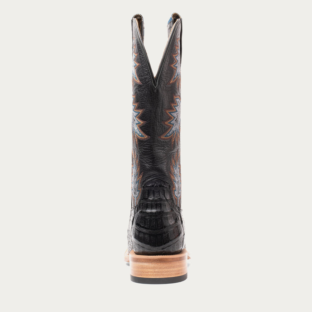 Back of black cowboy boot on white background