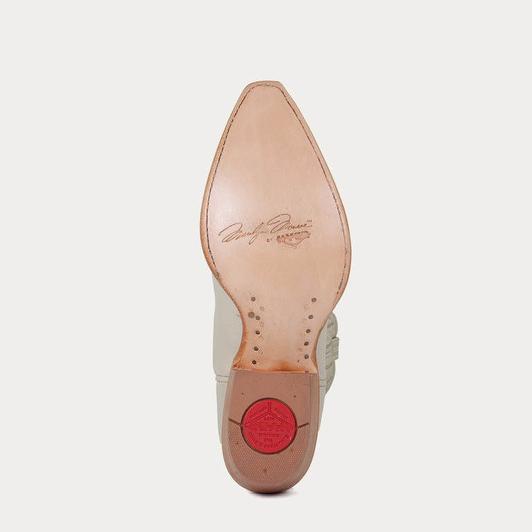 Tan leather sole of cowboy boot with "Marilyn Monroe by HYER" stamped on sole on a light gray background
